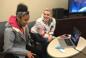 picture of student and Office of General Services staff member working on a laptop computer