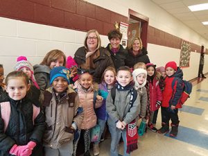 picture of 2019 Friend of Education Brenda Zawitkowski surrounded by elementary students
