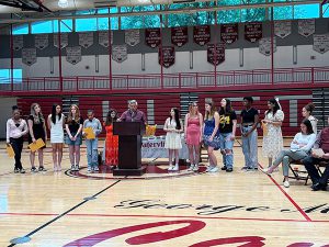 Members of girls soccer team receive awards from coach 