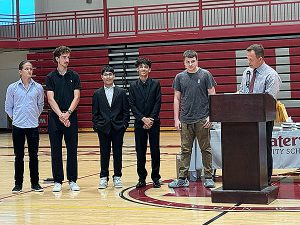 Members of boys soccer team receive awards from coach 