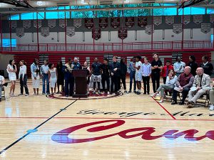 Members of track and field team receive awards from coach 