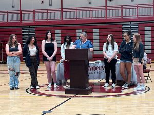 Members of volleyball team receive awards from coach 