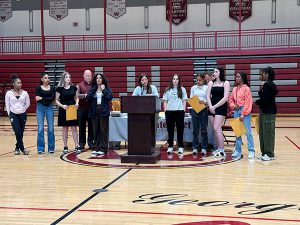 Members of girls basketball team receive awards from coach 
