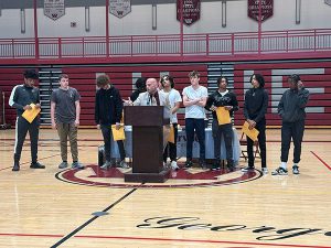 Members of boys basketball team receive awards from coach 