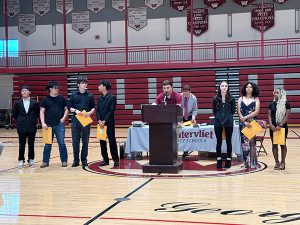 Members of wrestling team receive awards from coach 