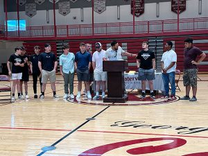 Members of baseball team receive awards from coach 