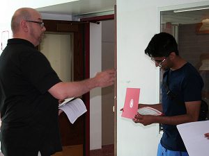 Science department chairperson presents scholarship award to high school student