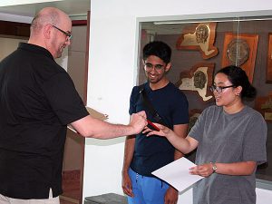 Science department chairperson presents scholarship award to high school student