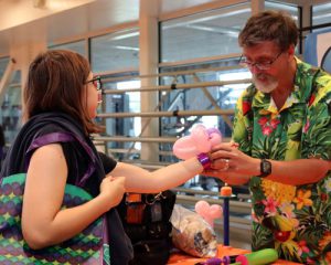 Student receives a twisty balloon sculpture