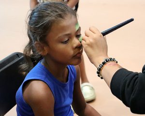 Student getting design painted on face