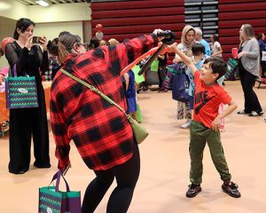 A student and family member dual with balloon swords