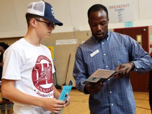 A student talks with a college admission representative