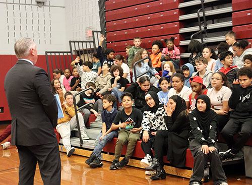 Assembly member takes questions from students who have their hands raised