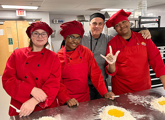 Three students and an educator in the kitchen lab at the Capital Region BOCES Career and Technical Education Center in Albany