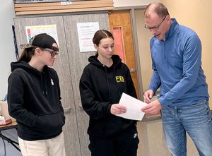 Two students talk with an educator at the Capital Region BOCES Career and Technical Education Center in Albany