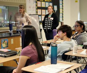 Students listen as scientists present information on careers and educational journeys