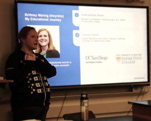 A scientist stands in front of class speaking to students about careers