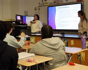 A scientist discusses the pros and cons of nuclear energy with students 